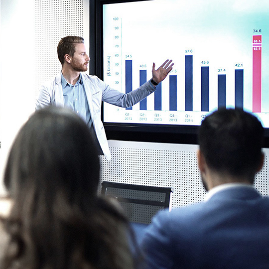 man showing graphs in a meeting